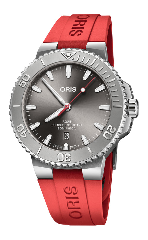 The Oris Aquis Date Relief is a silver dive watch with a grey dial and a red rubber strap.