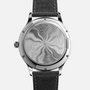 The Chopard L.U.C XPS 1860 Officer Limited Edition for Hodinkee features an intricate swirling pattern on the back and comes with a black leather strap.