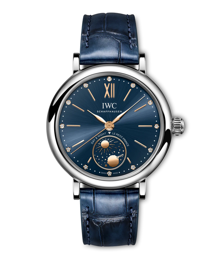 Silver-tone watch with dark blue dial, Roman numerals, diamond hour markers, and moon phase subdial on blue leather strap.