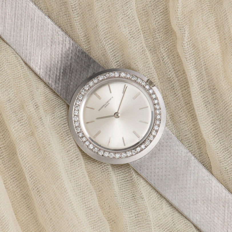 A Vacheron Constantin White Gold Diamond Bezel luxury wristwatch displayed on a textured cream fabric background.
