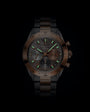 Bronze and black chronograph watch with luminous hour markers, three subdials, and mixed metal bracelet.