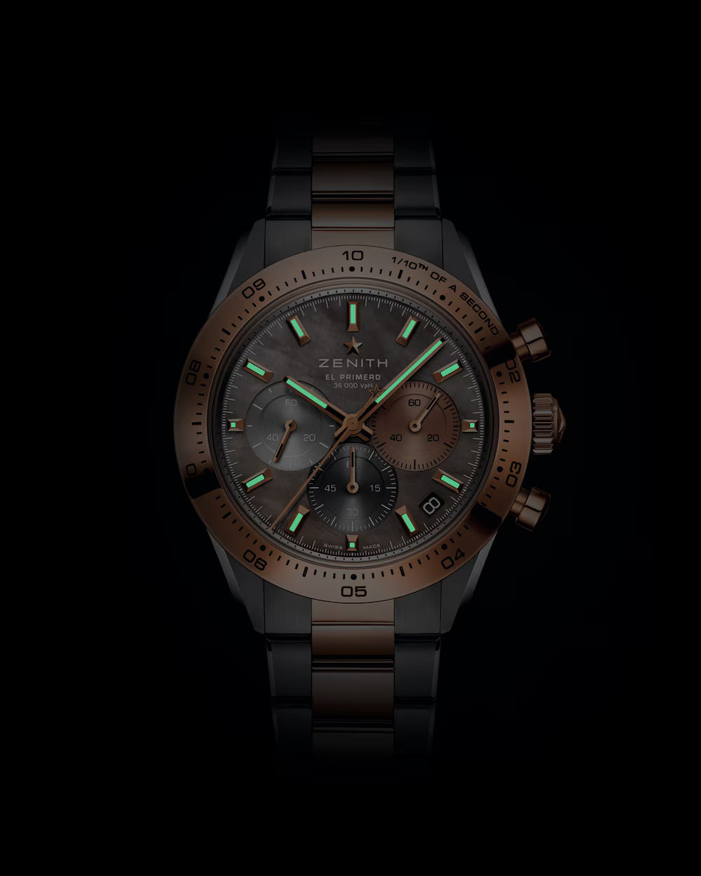 Bronze and black chronograph watch with luminous hour markers, three subdials, and mixed metal bracelet.