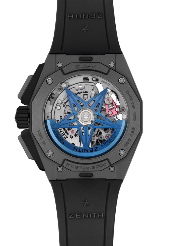 Close-up of the Zenith Defy Extreme Chroma's transparent case back reveals the El Primero 9004 movement, blue rotor, black microblasted titanium chronograph case, and black rubber strap with Zenith branding.