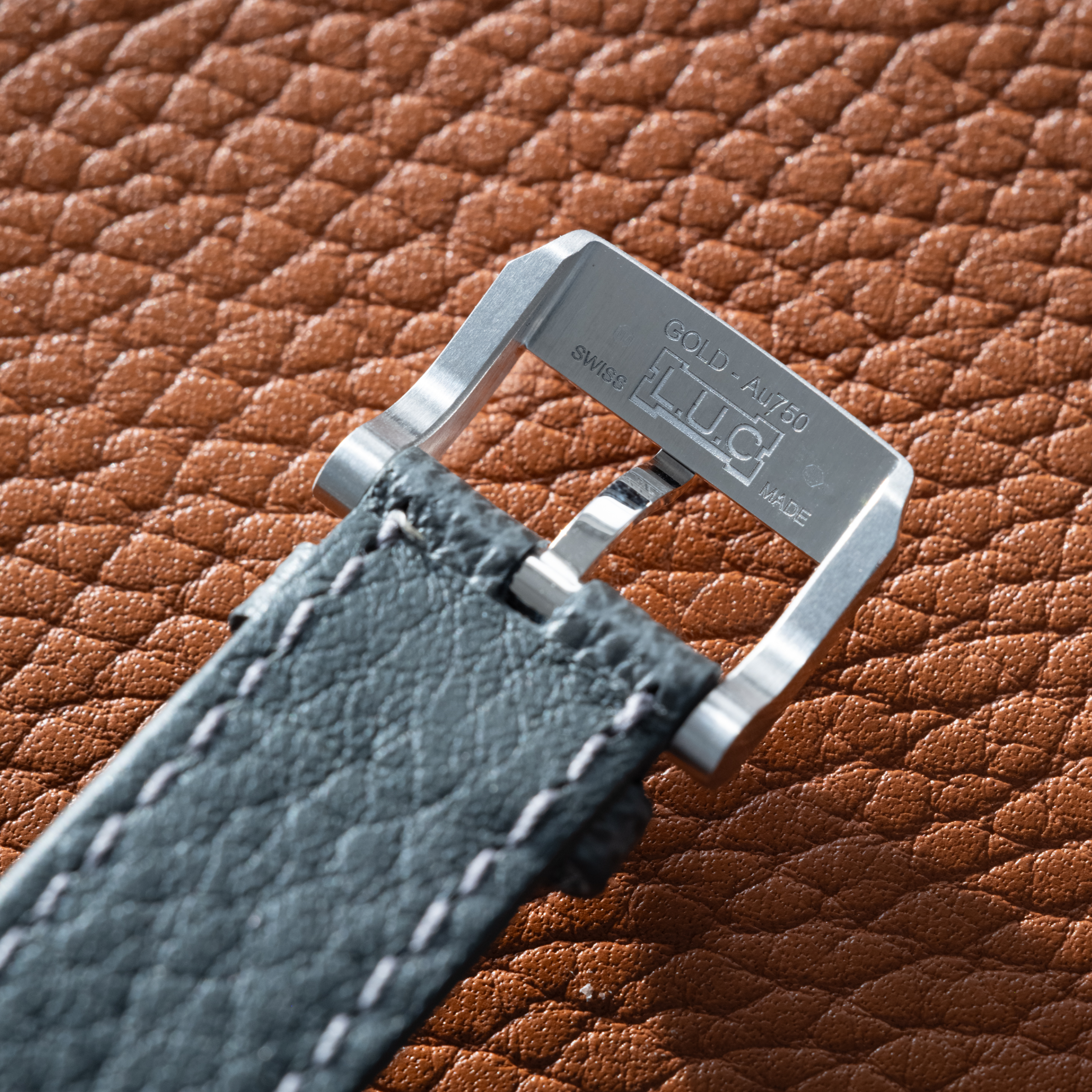 Close-up of the Chopard L.U.C XPS 1860 Officer Limited Edition For Hodinkee strap, featuring a silver “L.U.C CHOPARD” engraved buckle on textured brown leather and paired with a refined white gold case.