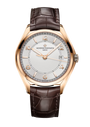 Rose gold watch with silver dial, Arabic numerals, date window, and dark brown crocodile leather strap.