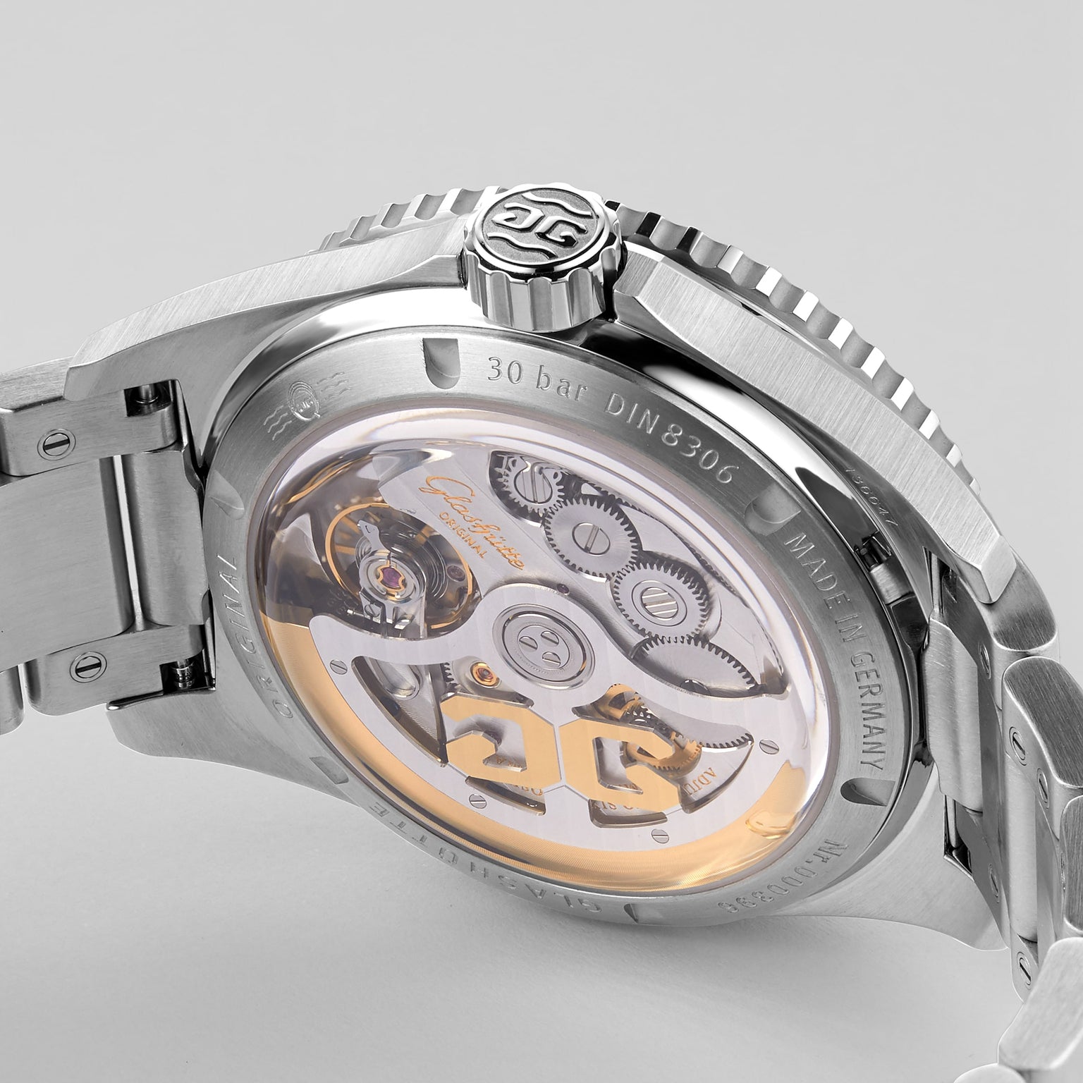 Side view of the Glashütte Original SeaQ Panorama Date luxury watch with a metal bracelet and exposed gears visible through its transparent case back.