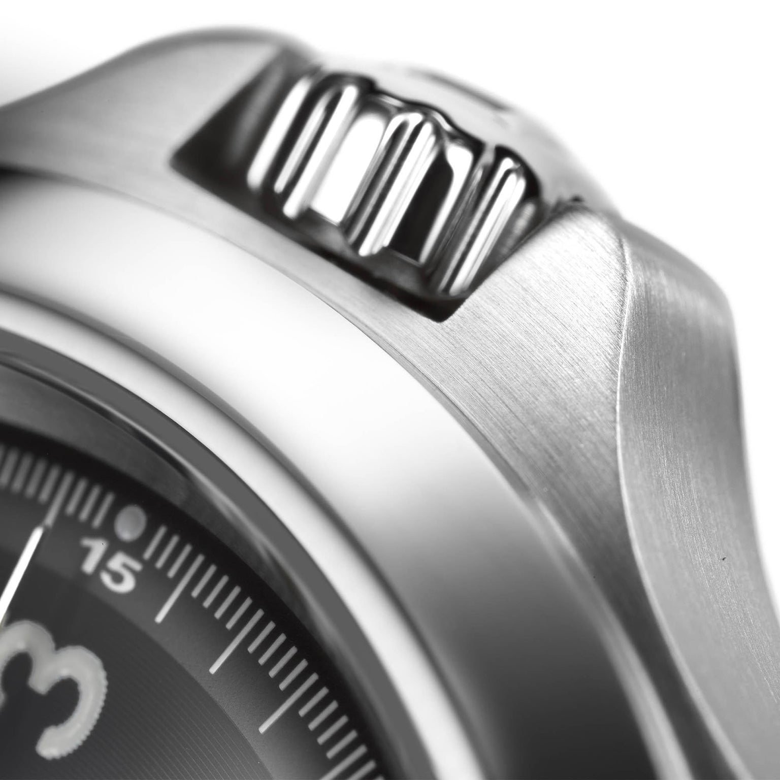 Close-up of the Hamilton Khaki Field King Auto’s stainless steel crown and bezel, showcasing brushed metal texture and a section of the dial with minute markers for legible military time reading.
