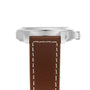 Side view of the Hamilton Khaki Field King Auto wristwatch featuring a stainless steel case, crown protectors, and a brown leather strap with white stitching.