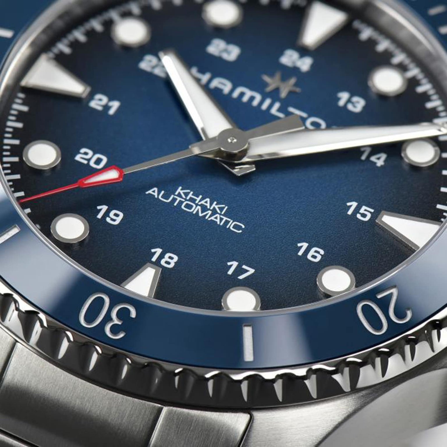 Close-up of the Hamilton Khaki Navy Scuba Auto wristwatch, featuring a blue dial, luminous markers, and a red-tipped second hand—an aquatic-inspired timepiece designed for high performance.