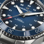 Close-up of the Hamilton Khaki Navy Scuba Auto wristwatch, featuring a blue dial, luminous markers, and a red-tipped second hand—an aquatic-inspired timepiece designed for high performance.