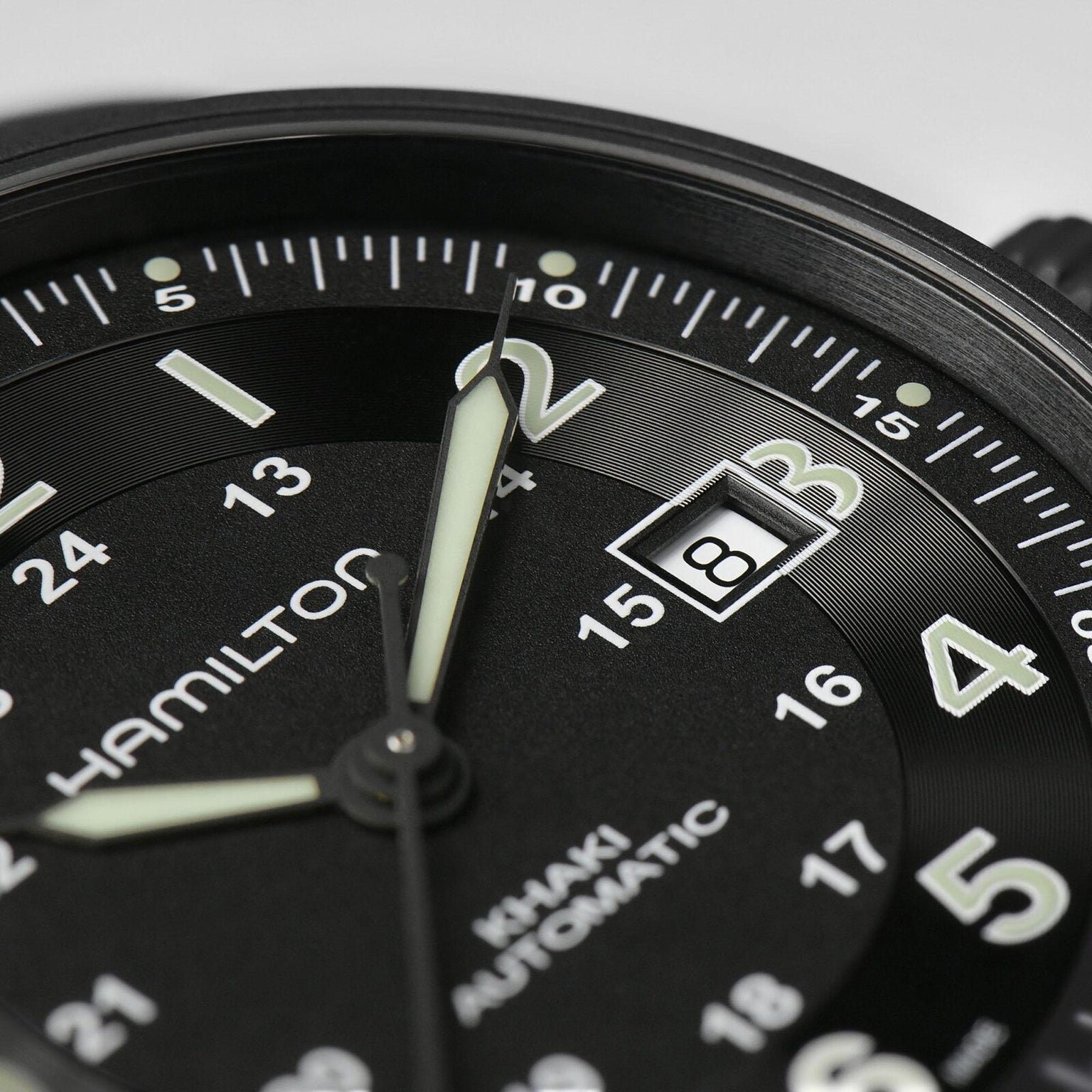 Close-up of a Hamilton Khaki Field Titanium Auto watch set to 2:00, featuring a date window with the number 3—a sleek men’s timepiece designed for both performance and style.