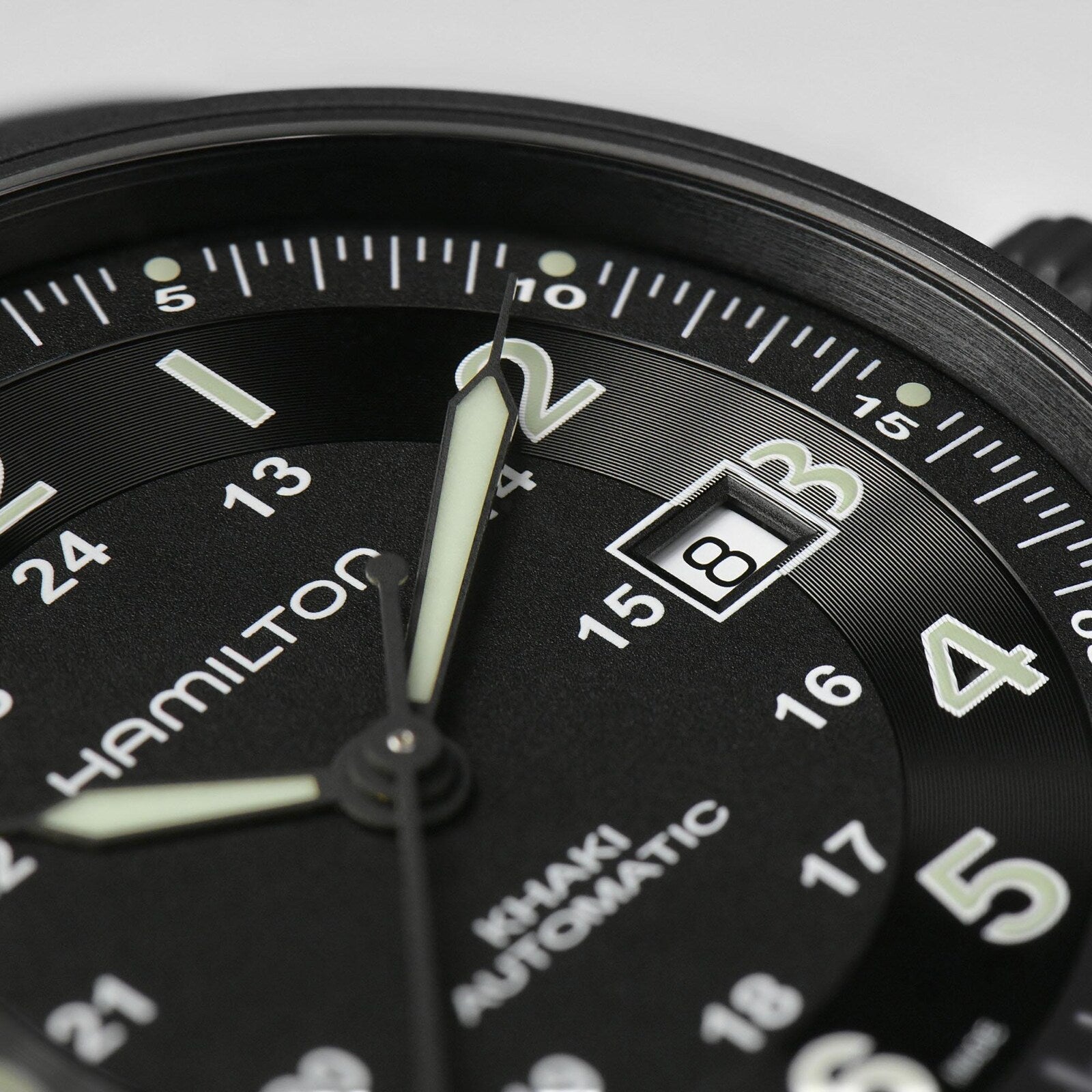 Close-up of a Hamilton Khaki Field Titanium Auto watch set to 2:00, featuring a date window with the number 3—a sleek men’s timepiece designed for both performance and style.