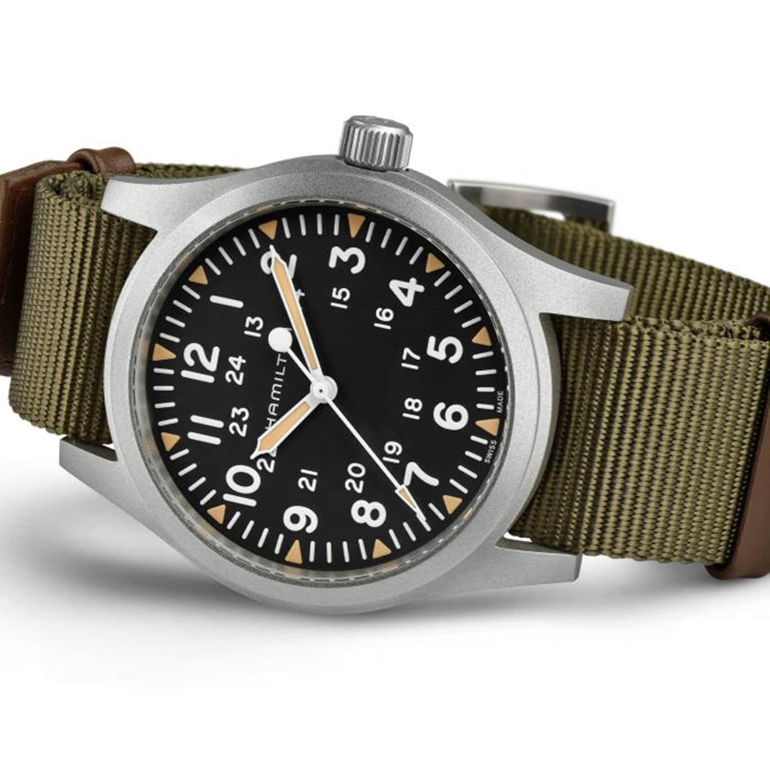 The Hamilton Khaki Field Mechanical 42mm is a soldier’s watch with a black dial, white numerals, green fabric strap, and both 12- and 24-hour markers for versatile timekeeping.