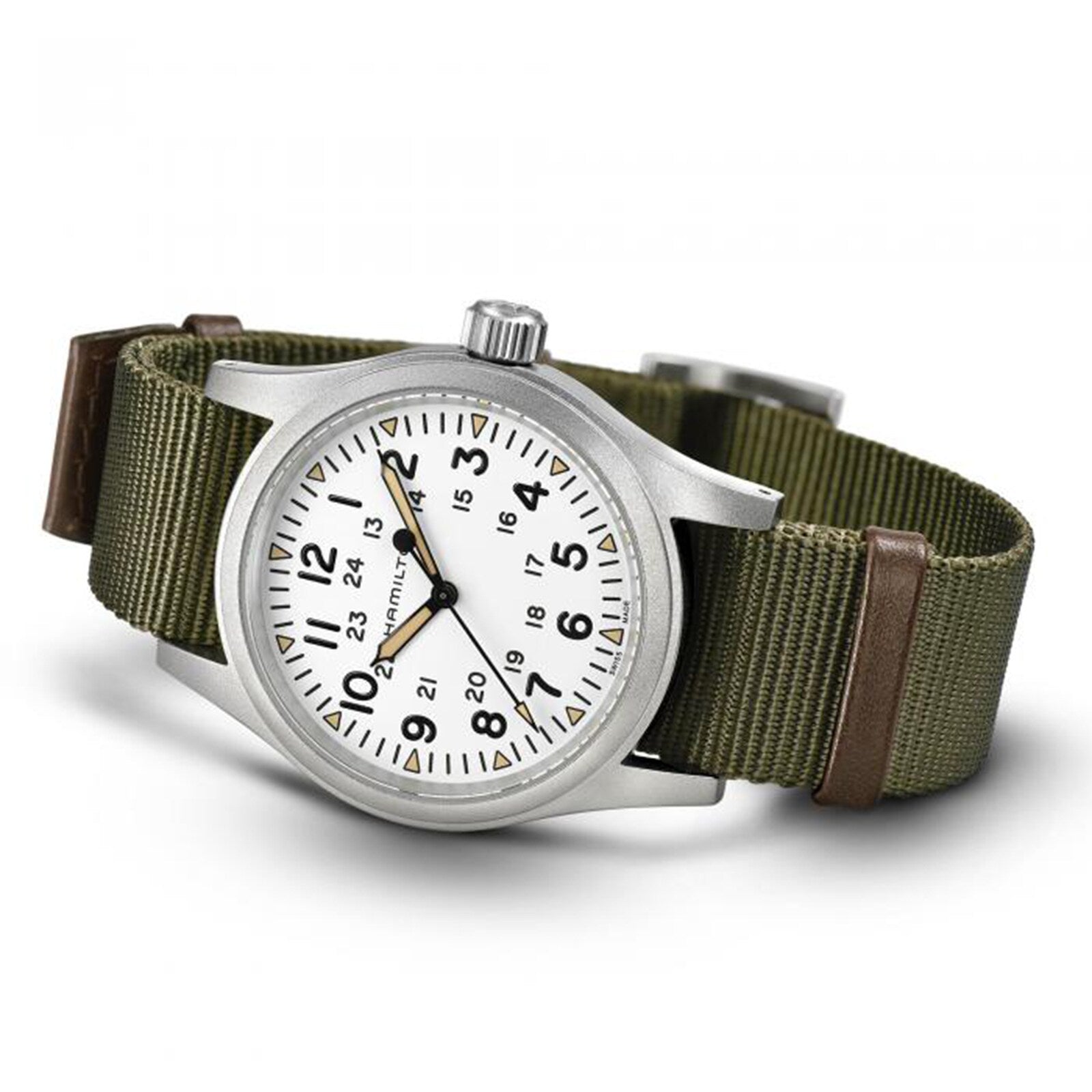The Hamilton Khaki Field Mechanical is a silver wristwatch with a white face, green fabric strap, and both 12-hour and 24-hour markings.