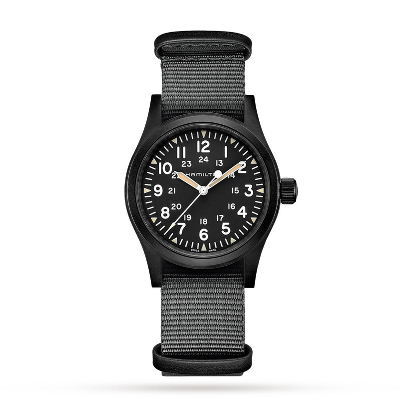The Hamilton Khaki Field Mechanical is a black analog wristwatch with white numerals, a black case, and a gray NATO strap, showcasing a classic design against a white background.