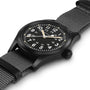 A Hamilton Khaki Field Mechanical wristwatch with white Arabic numerals, a black NATO strap, and a matte black case is displayed at an angle on a white background.