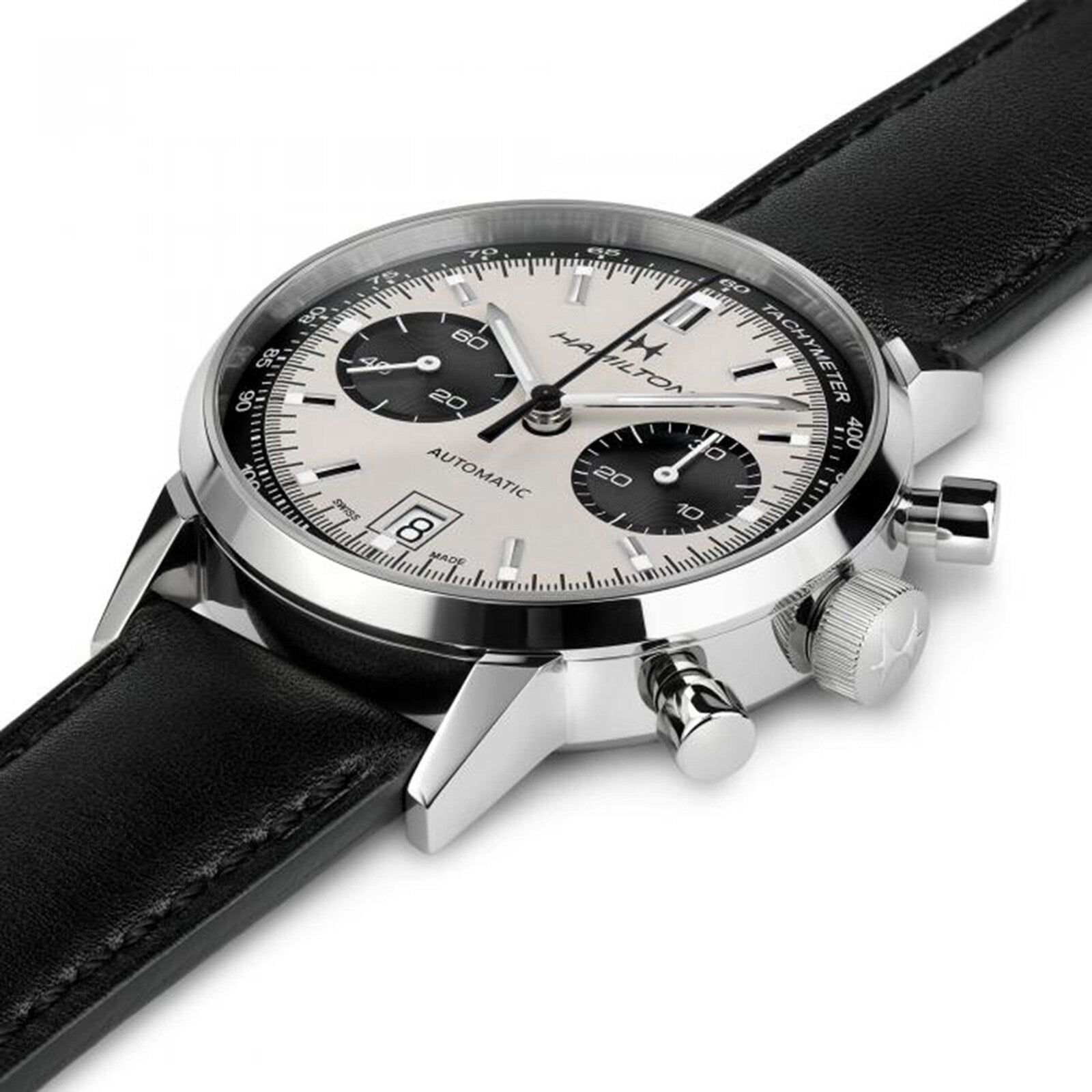 The Hamilton American Classic Intra-Matic Auto Chrono is a silver and black chronograph wristwatch featuring a leather strap, date display, and three subdials.