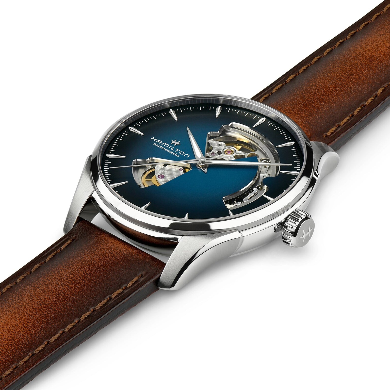 A close-up of the Hamilton Jazzmaster Open Heart Auto wristwatch, featuring a blue smoked skeleton dial, silver case, and brown leather strap that reveals stylish inner mechanical parts in a modern design.