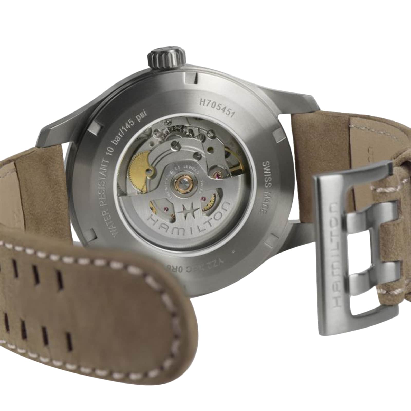 Close-up of the back of a Hamilton Khaki Field Titanium Auto, showcasing its automatic movement through a transparent caseback and a beige leather strap with Hamilton engraved on the buckle.