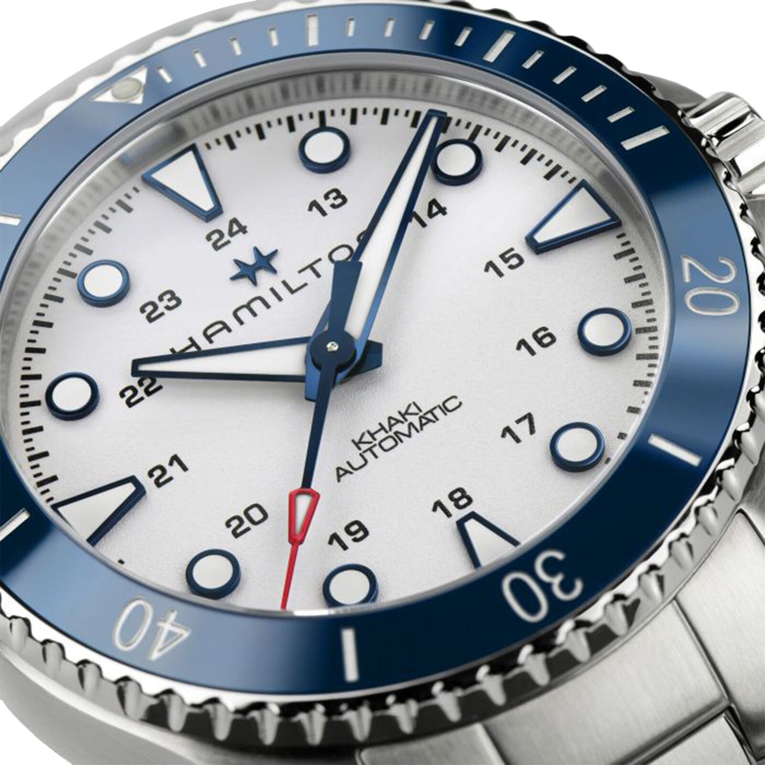 Close-up of the Hamilton Khaki Navy Scuba Auto wristwatch, featuring a white dial, blue ceramic bezel, luminous indices, and a stainless steel bracelet—an ideal summer accessory from Hamilton.