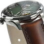 Close-up of the Hamilton Jazzmaster Open Heart Auto wristwatch featuring a silver case, green smoked dial with visible movement, and brown leather strap—ideal for fans of contemporary style.