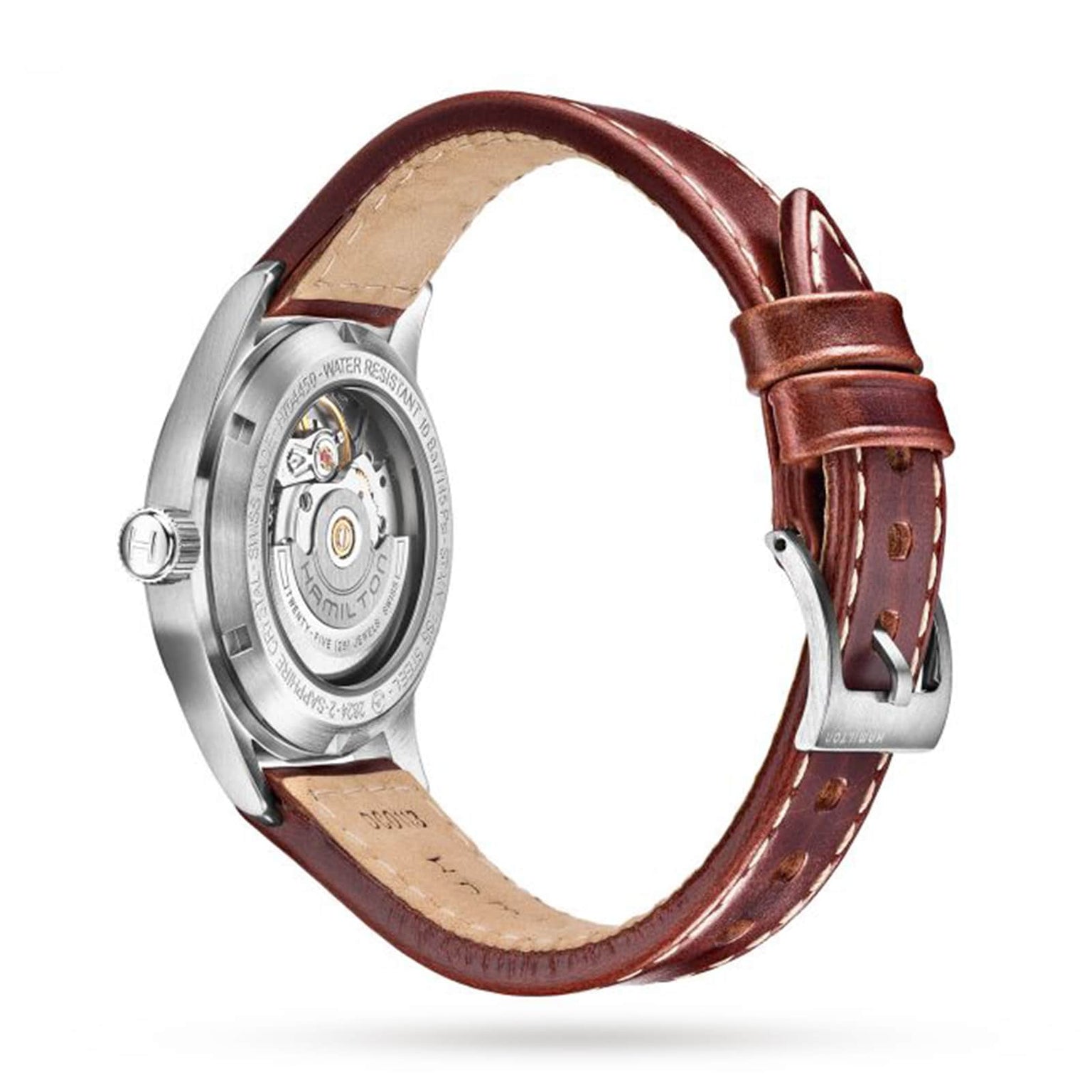 The Hamilton King Auto is a military-inspired watch with a brown leather strap and visible mechanical movement on its stainless steel case back, shown against a white background.
