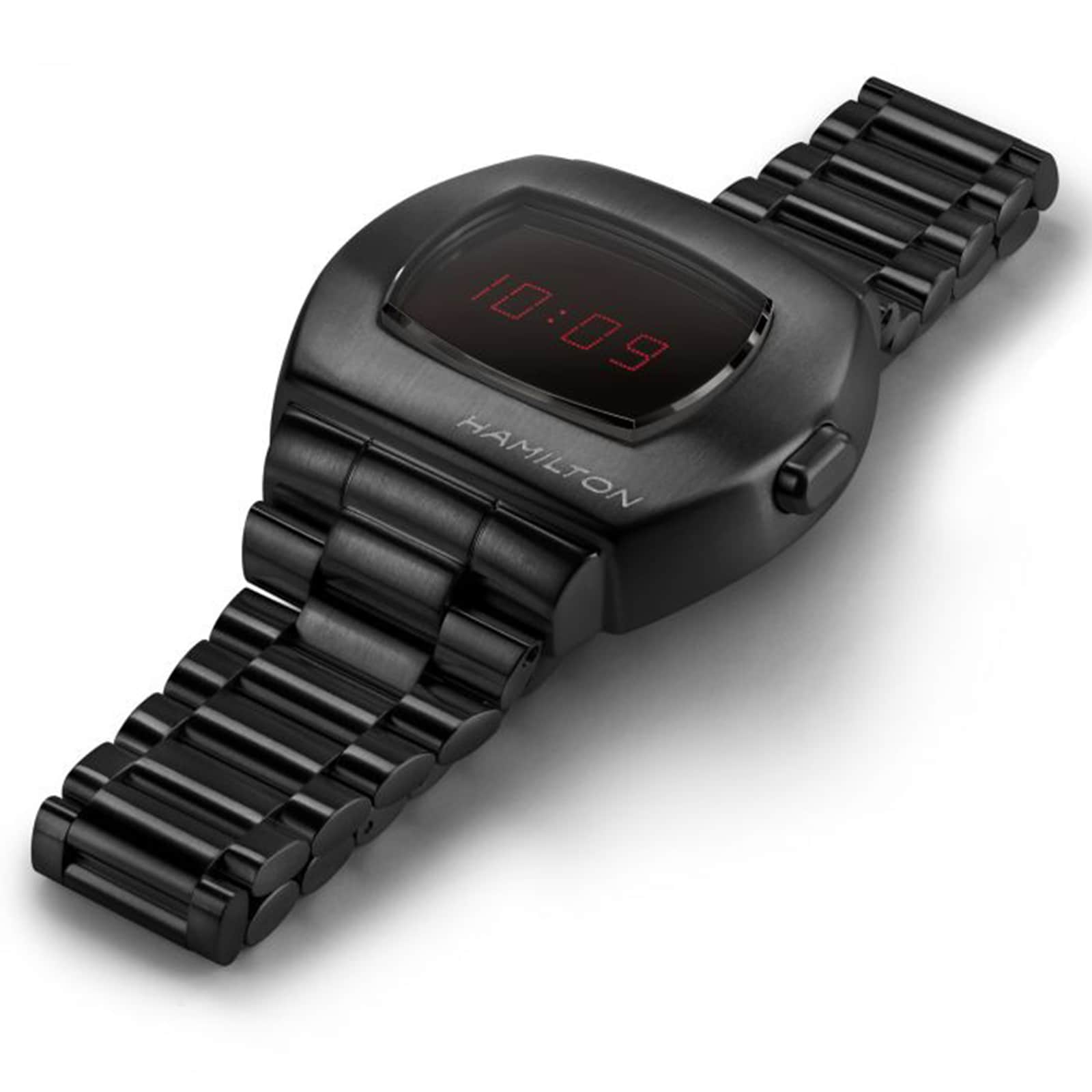 The Hamilton American Classic PSR Digital Quartz watch features a matte black finish, metal link band, and a red LED screen displaying the time 10:09.
