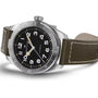 The Hamilton Khaki Field Expedition Auto is displayed on a white background, featuring a stainless steel case, Super-LumiNova® black dial with white numerals, and a brown leather strap.