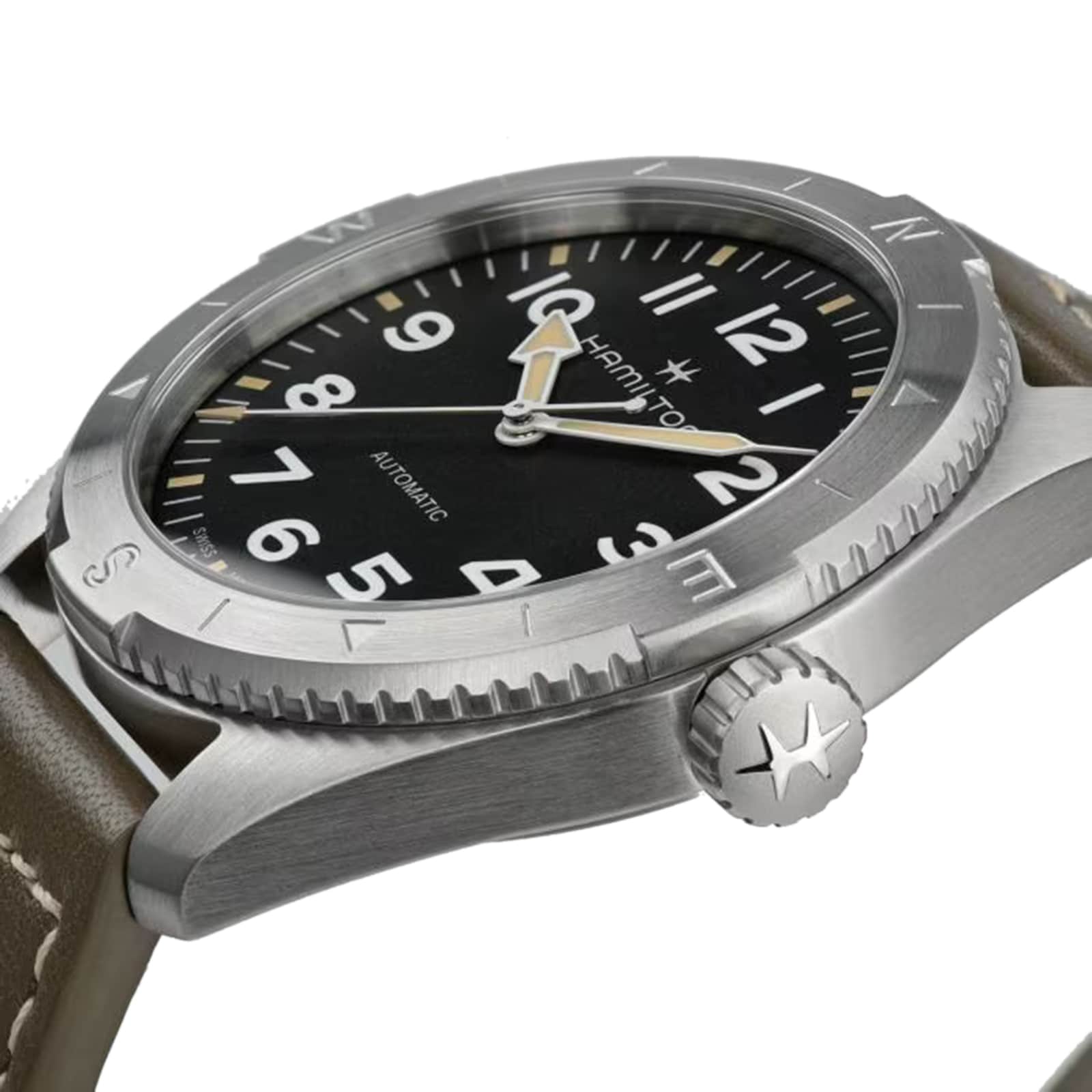 Close-up of the Hamilton Khaki Field Expedition Auto wristwatch featuring a black dial with white numerals, stainless steel case, silver bezel, and brown leather strap. The screw-down crown is engraved with a star.