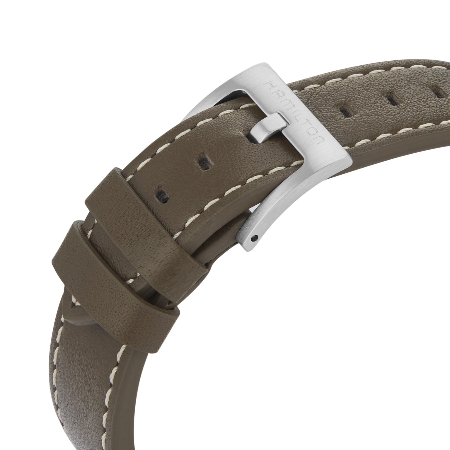 Close-up of the Hamilton Khaki Field Expedition Autos brown leather strap with white stitching and a silver buckle engraved with Hamilton, beside its stainless steel case that elevates the classic design.