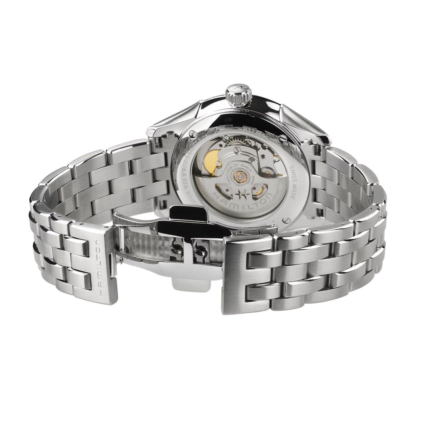 A close-up of the Hamilton Jazzmaster Open Heart Auto shows its silver stainless steel strap with an open clasp, revealing the automatic movement through the transparent case back.