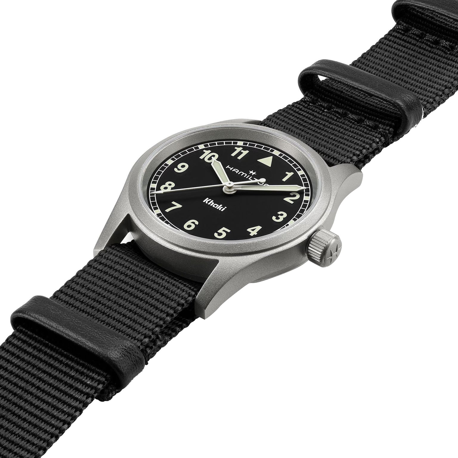 The Hamilton Khaki Field Quartz 33mm features a black NATO strap, black dial with white Arabic numerals, and luminous hands, capturing classic military style in an angled shot on a white background.