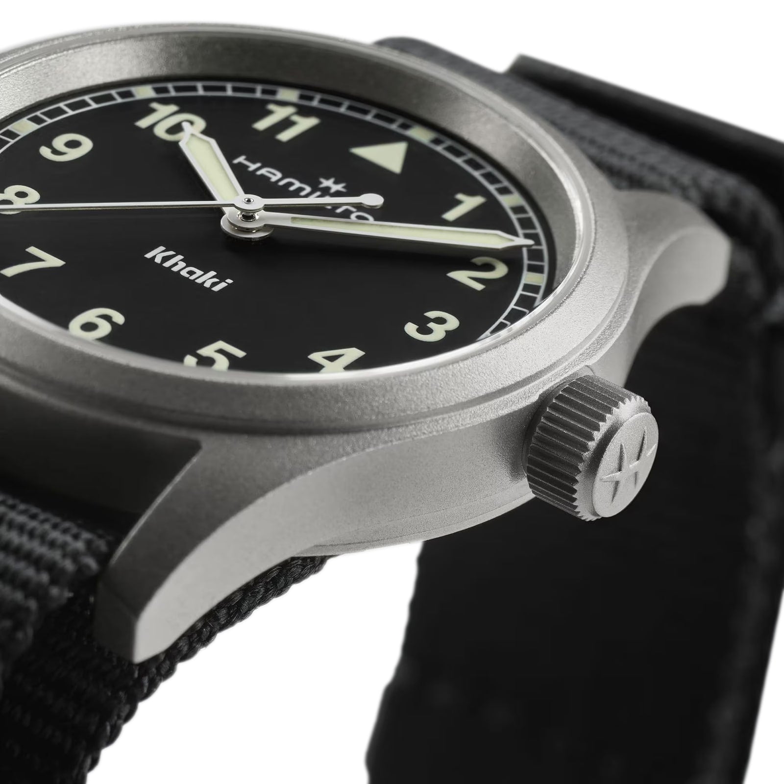 Close-up of the Hamilton Khaki Field Quartz 33mm watch, featuring a black dial with white Super-LumiNova indexes and a tough NATO strap, focusing on the crown and part of the stainless steel case.