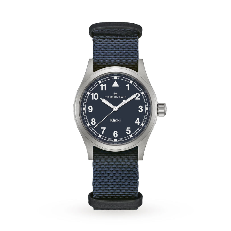 The Hamilton Khaki Field Quartz 38mm watch features a black dial with white numerals and a blue NATO strap, displayed on a white background to highlight its classic military heritage style.