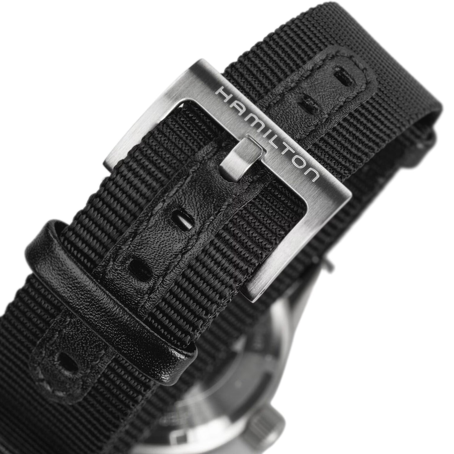 Close-up of the black Hamilton Khaki Field Mechanical watch strap and metal buckle, featuring the engraved Hamilton name and emphasizing its military-inspired design.
