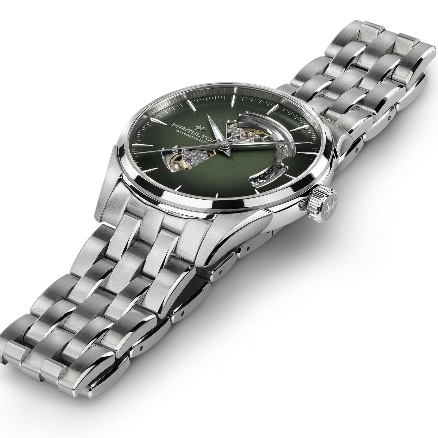 The Hamilton Jazzmaster Open Heart Auto 42mm is a silver wristwatch with a green dial, metal link band, and an exposed gear mechanism.