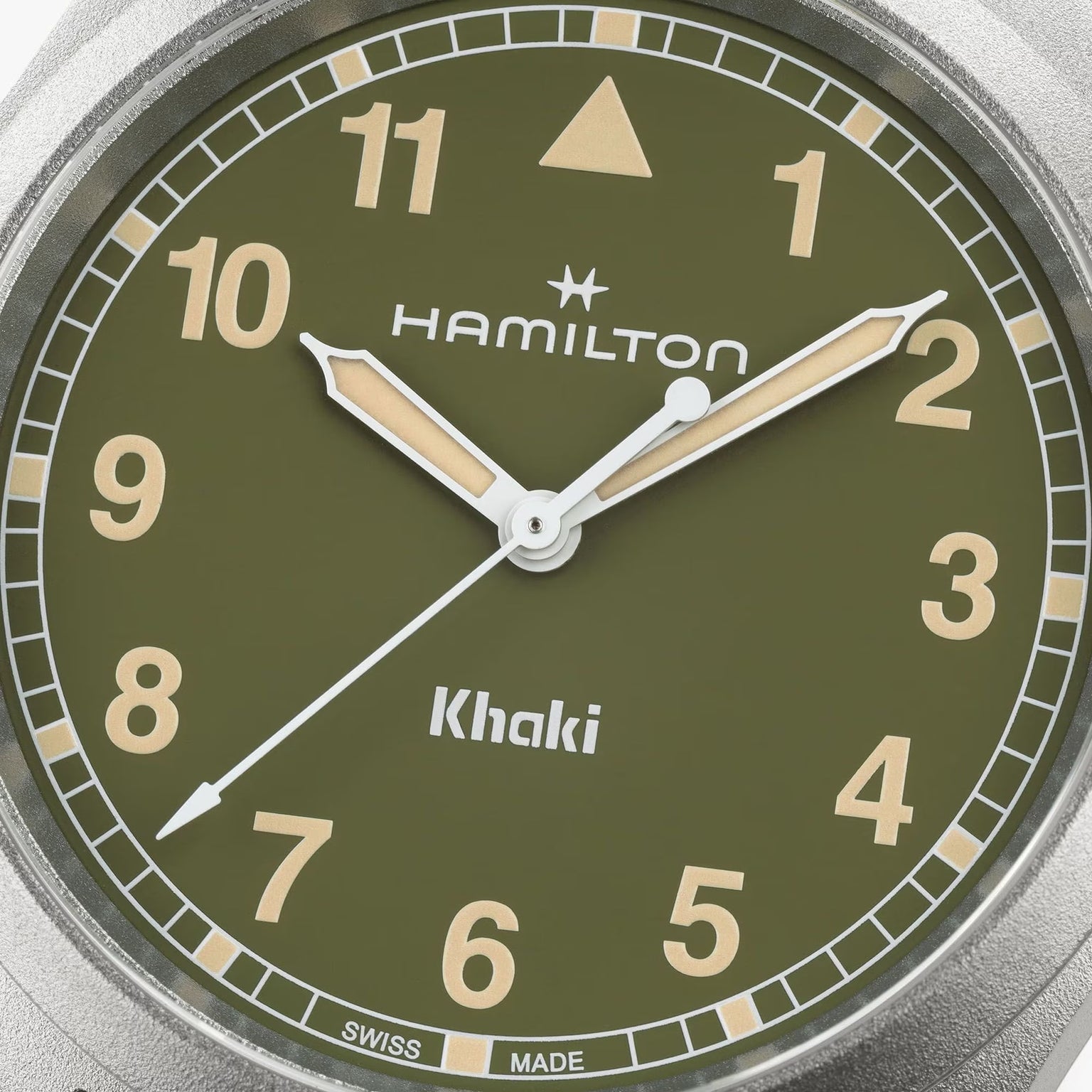 Close-up of a green Hamilton Khaki Field Quartz 38mm watch face displaying the time as 2:38:36.