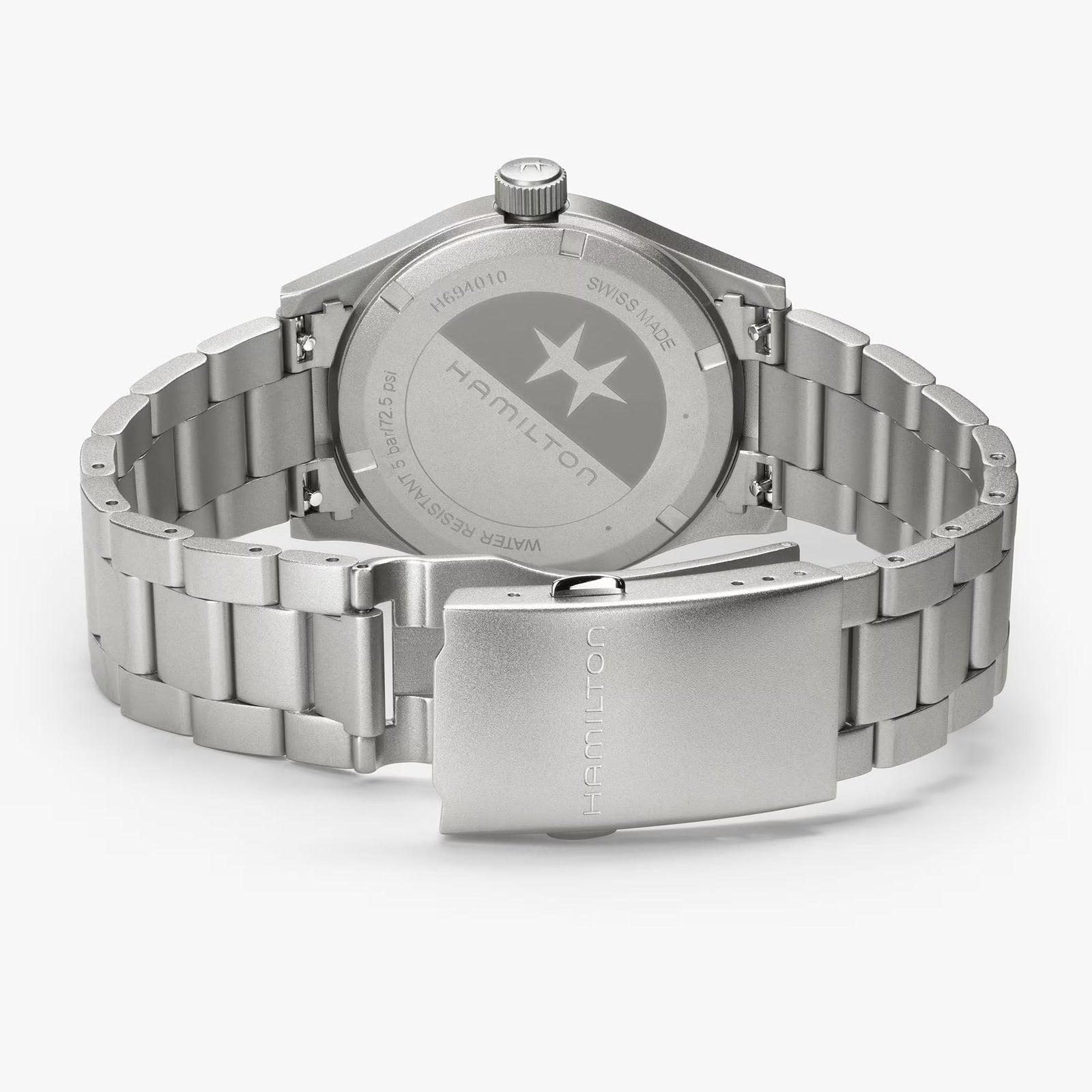 The Hamilton Khaki Field Quartz 38mm watch in stainless steel is displayed on a white background, highlighting its engraved case back and clasp.