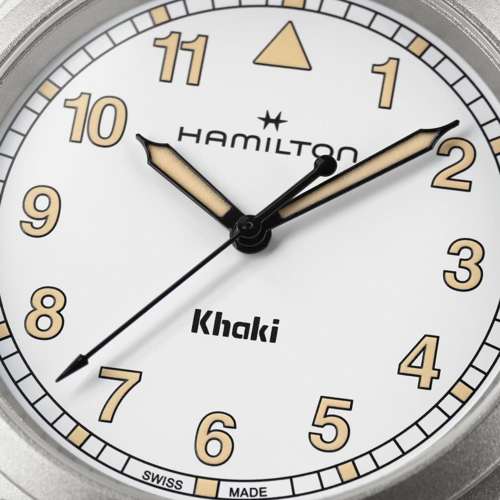 Close-up of a white Hamilton Khaki Field Quartz 33mm watch face by Hamilton displaying the time 10:09:37.