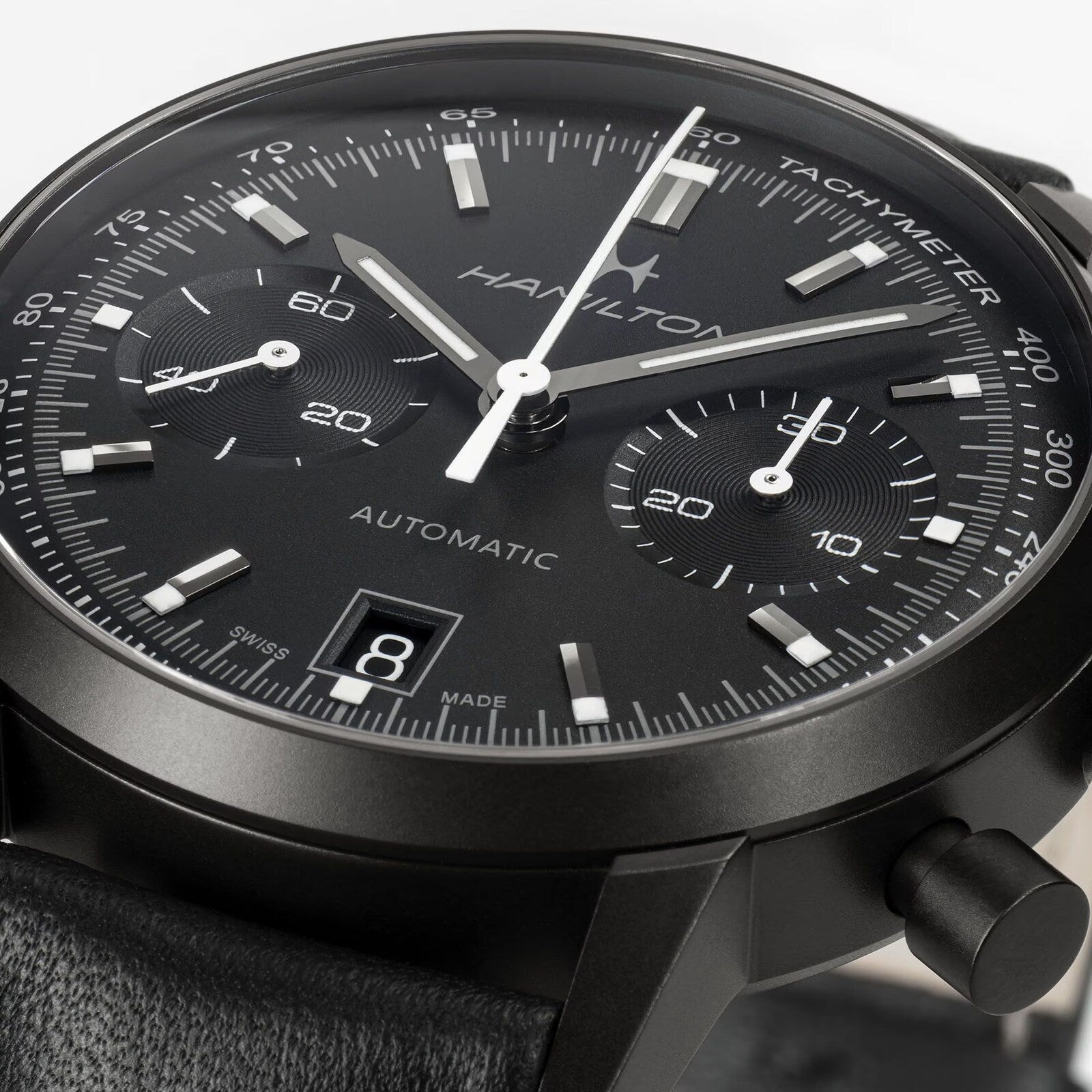 Close-up of a Hamilton American Classic Intra-Matic Auto Chrono, a black automatic chronograph watch featuring two subdials and a date display.