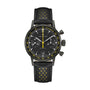 The Hamilton American Classic Intra-Matic Auto Chrono is a black chronograph watch featuring yellow accents and a perforated leather strap, displayed on a white background.