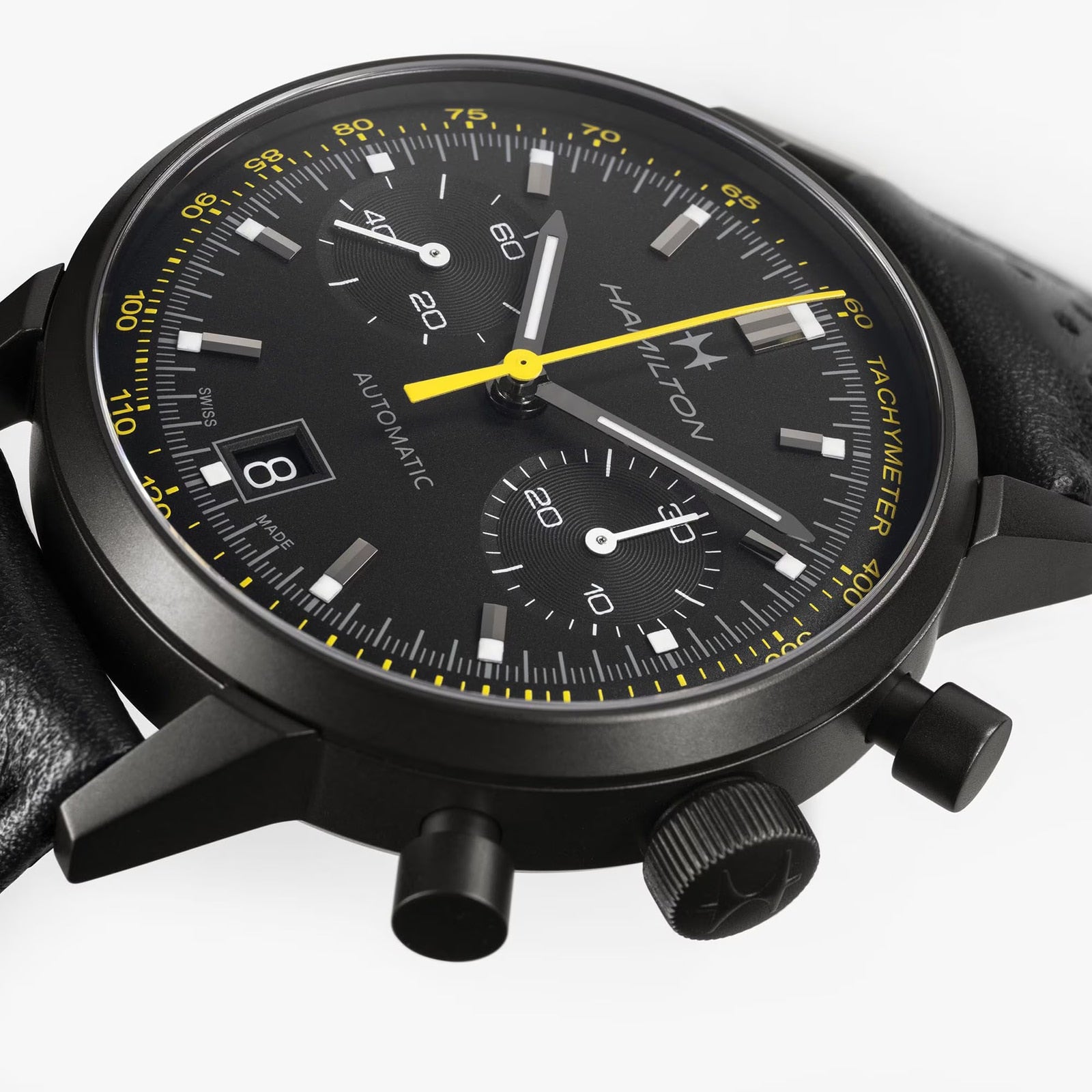 Hamilton American Classic Intra-Matic Auto Chrono with yellow accents, black leather strap, and a tachymeter bezel.