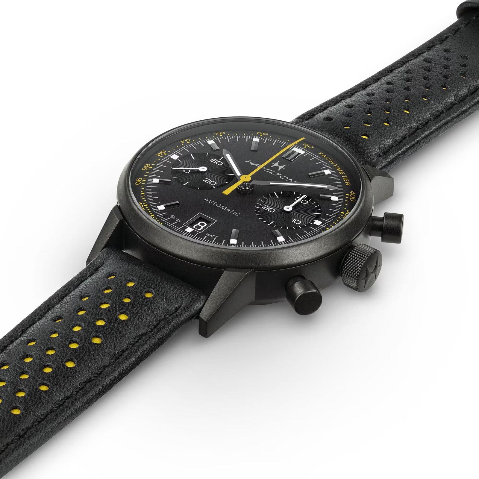 The Hamilton American Classic Intra-Matic Auto Chrono is a black chronograph wristwatch with yellow accents and a perforated leather strap, displayed on a white background.