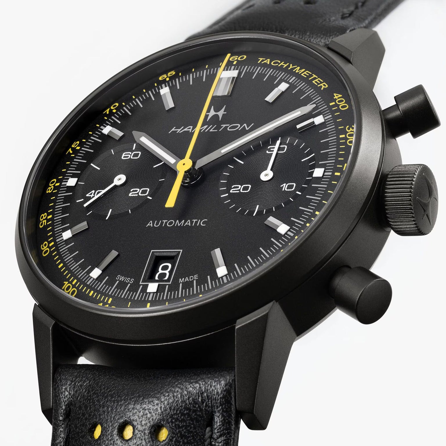 Hamilton American Classic Intra-Matic Auto Chrono chronograph watch with yellow accents, black leather strap, and visible date display.
