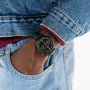 A person in denim has their hand in their jeans pocket, wearing a Hamilton American Classic Intra-Matic Auto Chrono wristwatch.