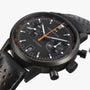 Close-up of the Hamilton American Classic Intra-Matic Auto Chrono, a black chronograph watch featuring a perforated leather strap and orange accents.