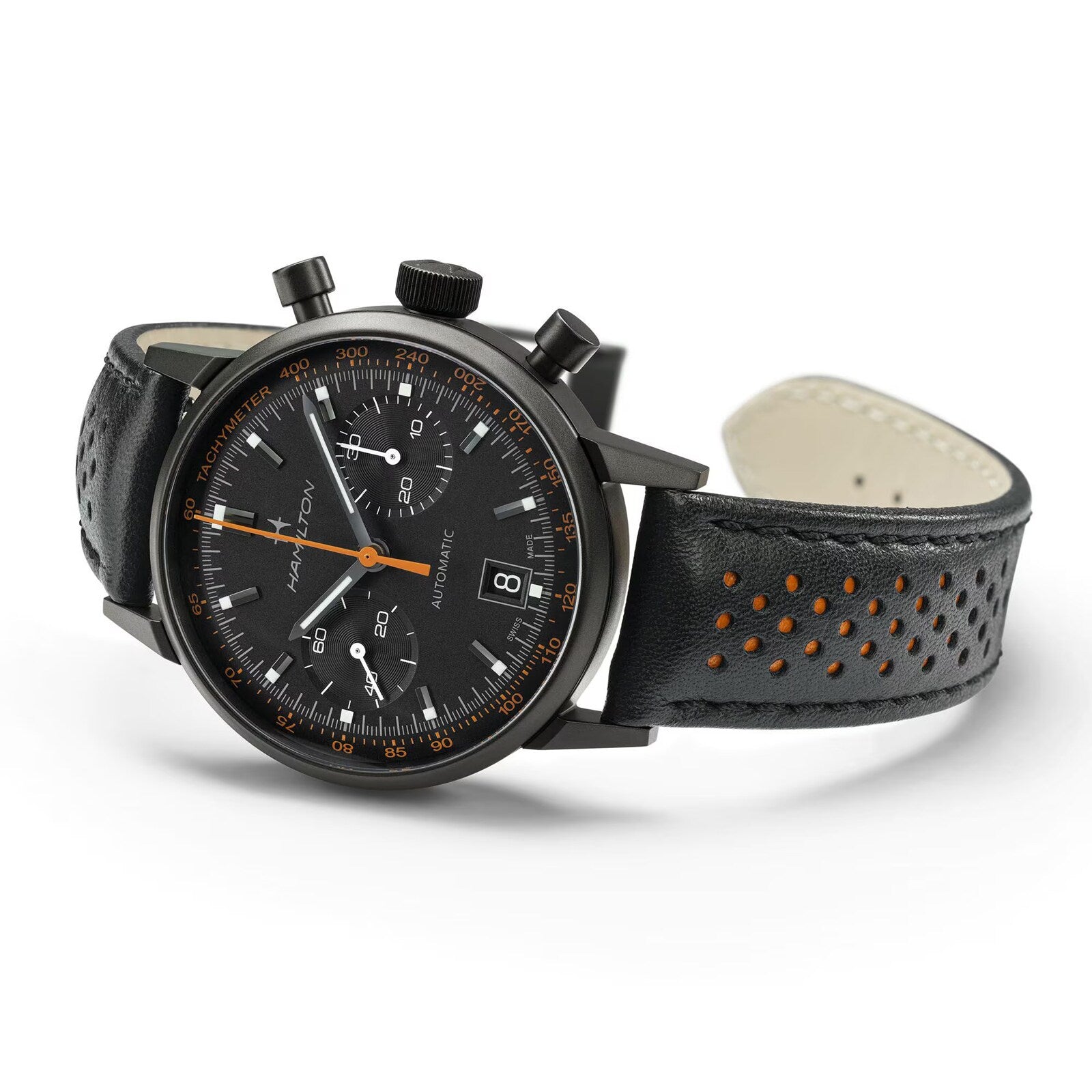 The Hamilton American Classic Intra-Matic Auto Chrono is a black chronograph wristwatch with a black leather strap featuring orange perforations and an orange second hand.