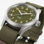 Close-up of the Hamilton Khaki Field Quartz 38mm watch featuring an olive green dial and fabric strap.