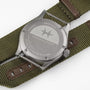 Back of a Hamilton Khaki Field Quartz 38mm wristwatch on an olive green nylon strap with brown leather accents.