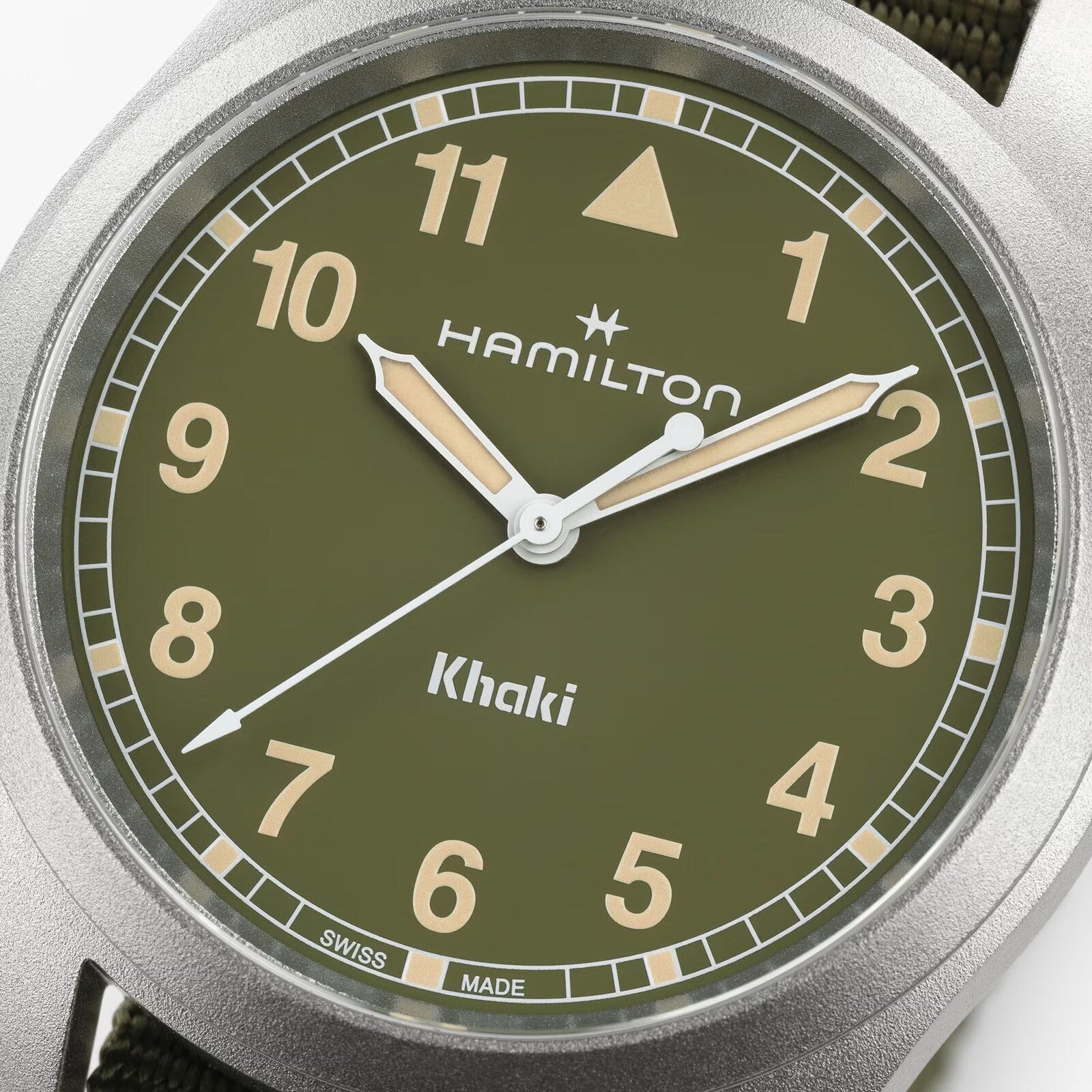 Close-up of the Hamilton Khaki Field Quartz 38mm watch, featuring an olive green dial with beige hour markers and hands.